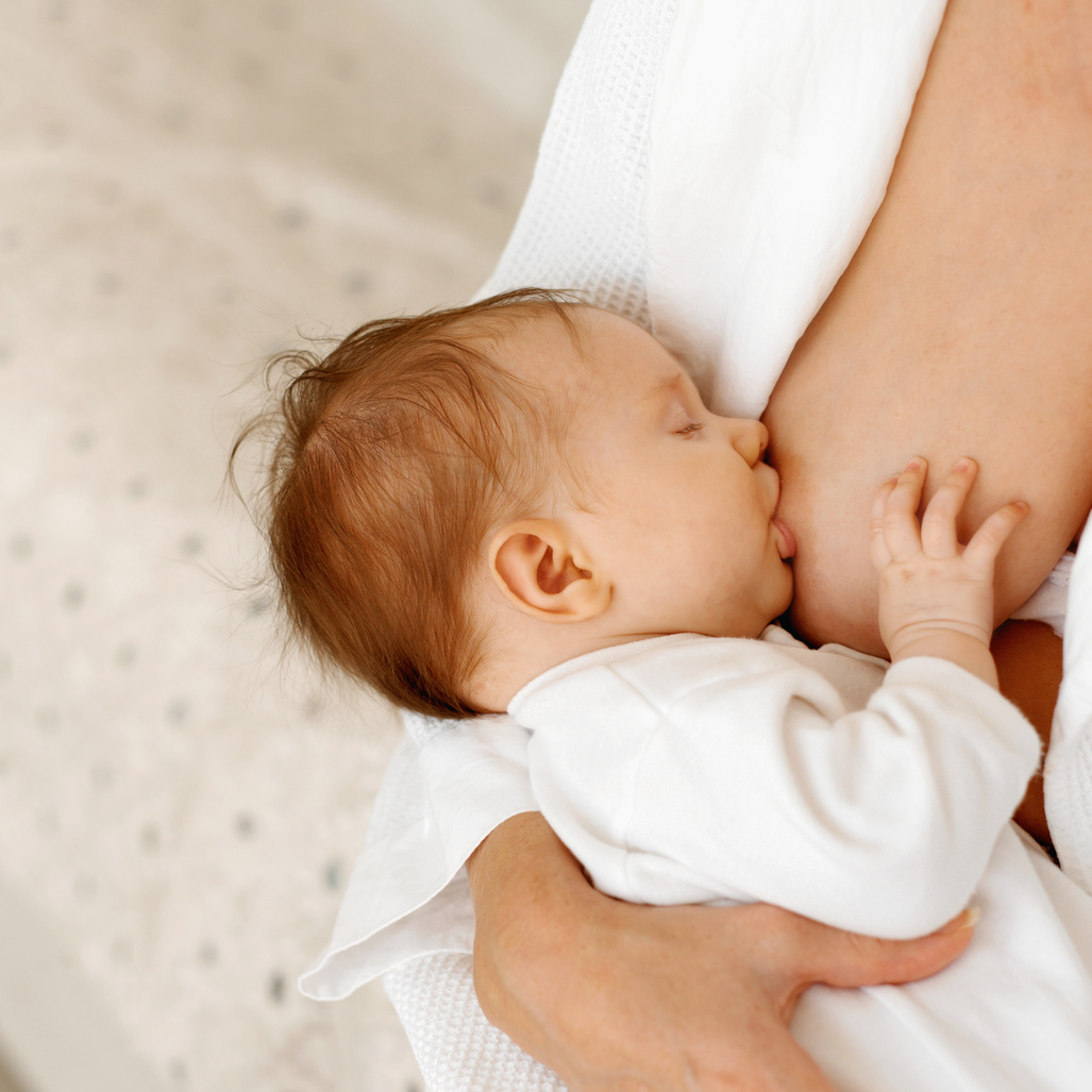 close up view of a baby (6-12 months) breastfeeding